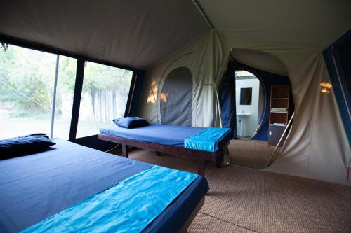a bedroom with two beds in a tent at Yala Villa in Yala
