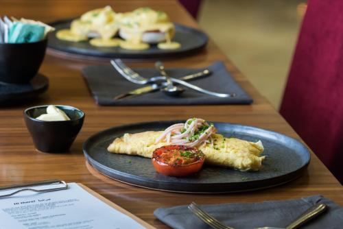 a table with two plates of food on a table at Radisson Blu Resort & Spa Cesme in Cesme