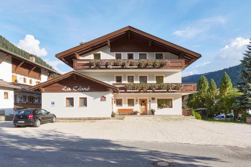 a building with a car parked in front of it at La Cianò in Corvara in Badia