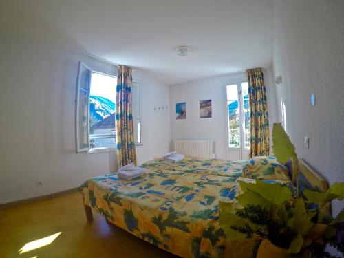 a bedroom with a bed and a window at Le Rabuons in Saint-Étienne-de-Tinée