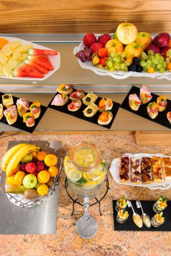 a table filled with different types of fruits and desserts at Seminarhotel Lengbachhof GmbH in Altlengbach