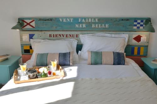 a bedroom with a bed with a tray of food on it at B&B Villa Du Roc Fleuri in Cannes