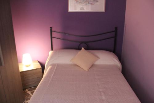 a bedroom with a bed with a pillow and a lamp at B&B President Palace in Riposto