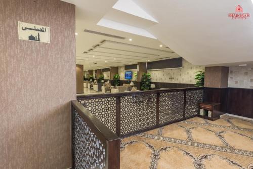 a lobby of a hotel with a staircase and a bar at فندق شروره بلازا الفندقية in Sharurah