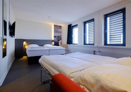 Säng eller sängar i ett rum på Zleep Hotel Ishøj
