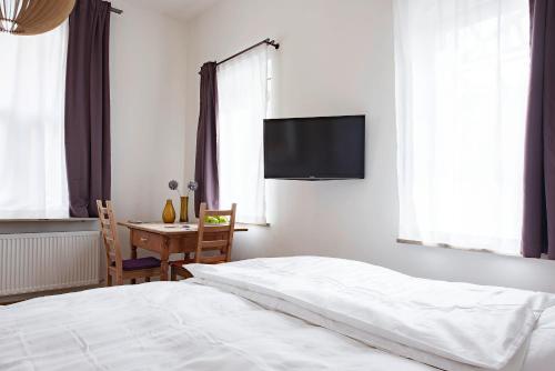 a bedroom with a bed and a table and a tv at Apartment St Johannis in Nürnberg
