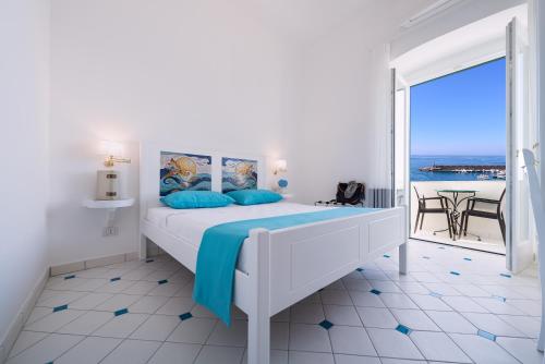 a bedroom with a bed with a view of the ocean at Vista d'Amalfi in Amalfi