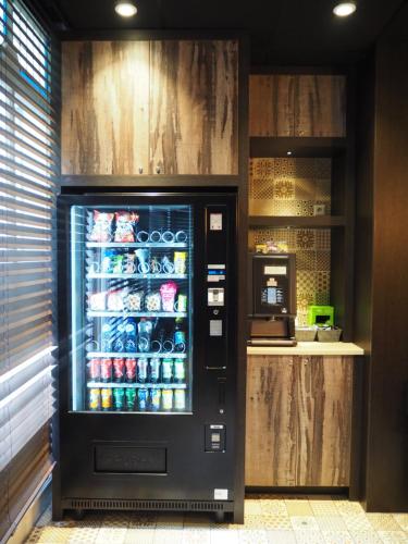 a vending machine with drinks inside of it at Blossoms City Hotel in Amsterdam