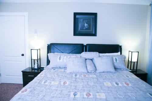 a bedroom with a large bed with pillows at Mountain View Radium Condo - Copper Horn Village in Radium Hot Springs