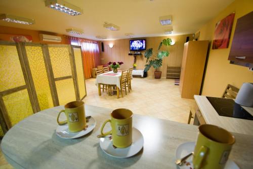 two coffee cups sitting on a table in a kitchen at Arciau Juros in Palanga