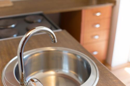 a kitchen sink with a faucet on a counter at Beautiful View Of Sarajevo Center in Sarajevo