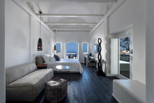 a living room with a couch and a table at Cavo Tagoo Santorini in Imerovigli