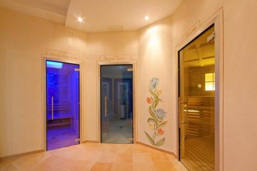 a hallway with two doors and a painting on the wall at Hotel Cristallo in Andalo