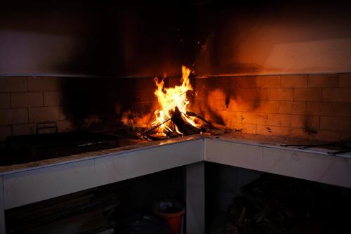 a fireplace with a fire in the middle of it at Villa Palloma in Baška Voda