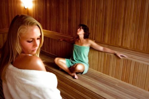 two women are sitting in a sauna at Ephesia Hotel - All Inclusive in Kusadası