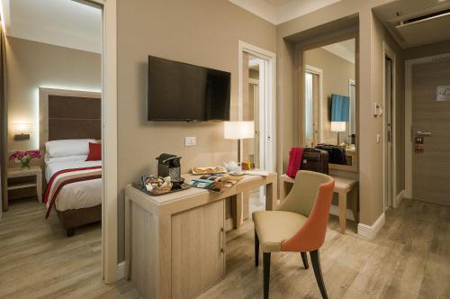 En eller flere senger på et rom på Hotel Villa Maria Regina