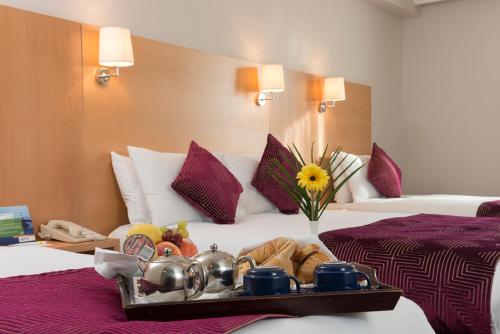 a tray of food on a bed in a hotel room at Park Inn by Radisson Shannon Airport in Shannon
