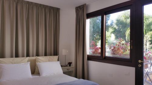 a bedroom with a bed and a window at B & B Villa Flora in Mondello