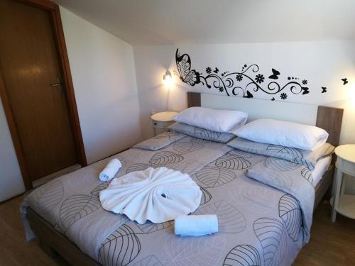 a bedroom with a bed with two towels on it at Villa Radovic in Cavtat
