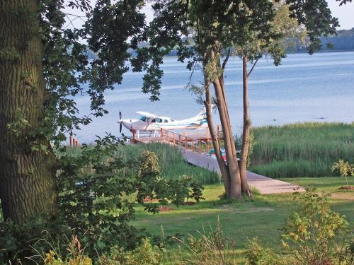 a boat is parked on the side of the water at Falk Seehotel Plau am See in Plau am See