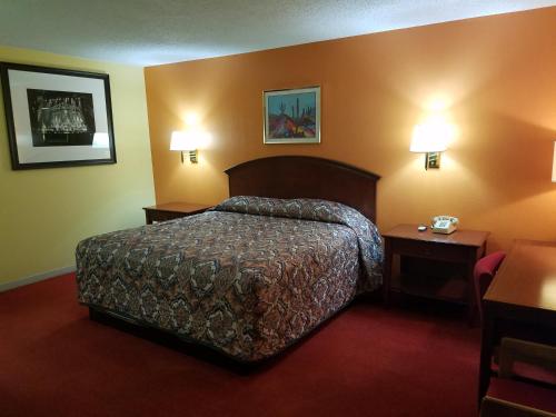 a hotel room with a bed and two night stands at Executive Inn in Panhandle