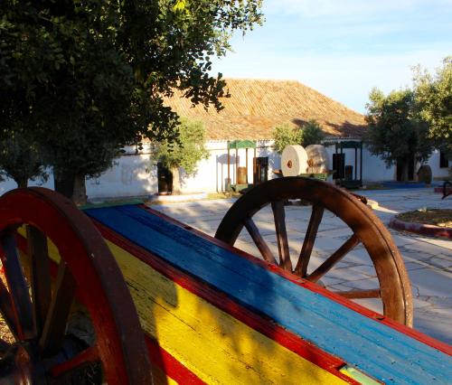 a colorful wooden bench with a wooden wheel at Hotel de Charme Capela das Artes in Armação de Pêra