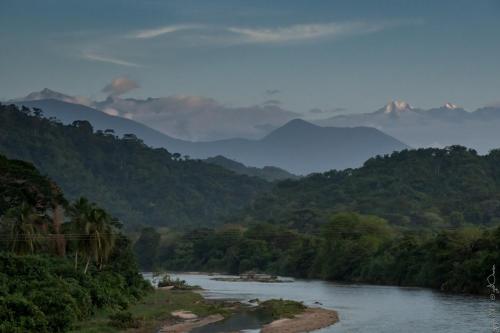 a view of a river with mountains in the background at Hostal La Media Luna Palomino in Palomino