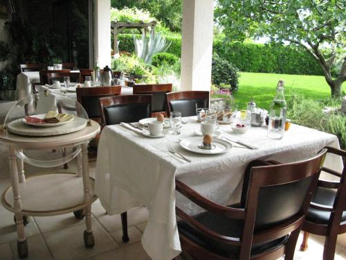 a table with a white table cloth on a patio at Bed and Breakfast Villa Iris in Mošćenička Draga