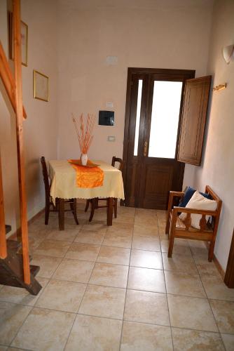 a dining room with a table and a table and chairs at Hotel Valle del Cedrino in Galtellì