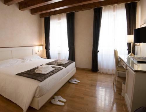 a hotel room with a bed with towels on it at Albergo Mazzanti in Verona