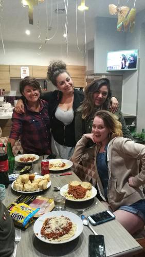 a group of women standing around a table with food at Meyerbeer Beach in Nice