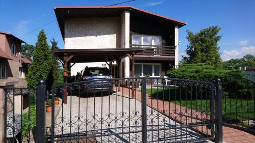 a gate in front of a house with a car at Privát 347 in Broumov