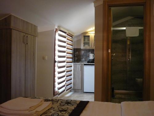 a bedroom with a bed and a kitchen at Street61 Apart Hotel in Sarigerme