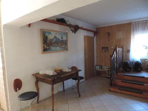 a room with a table and chairs and a staircase at Western Penzion in Ružomberok