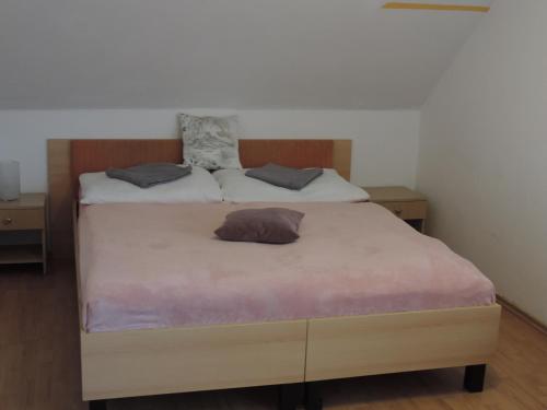 a bedroom with a bed with two pillows on it at Western Penzion in Ružomberok
