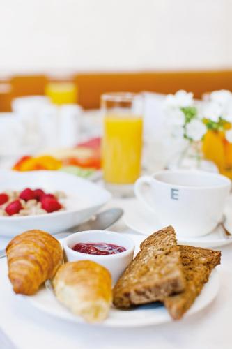 a table with a plate of food with bread and toast at Elite Plaza Hotel Malmö in Malmö