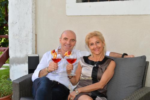 a man and a woman holding glasses of wine at Residence Cà di Capri in Bussolengo