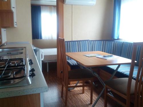 a small kitchen with a table and a stove at Campeggio Amici di Lazise in Lazise