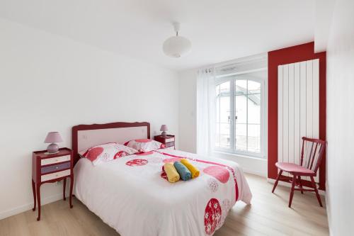 a bedroom with a bed and two chairs and a window at Corneille by Cocoonr in Rennes