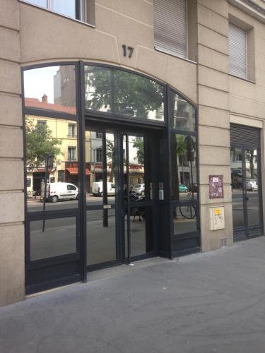 an entrance to a building with revolving glass doors at Chez Marie in Lyon
