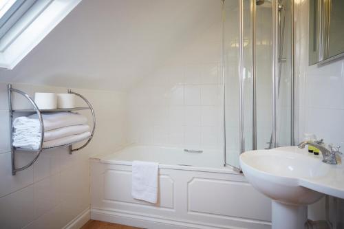 a white bathroom with a sink and a shower at The Terrace Lodge Hotel in Yeovil
