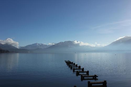 a row of docks in the middle of a lake at Centre Jean XXIII in Annecy