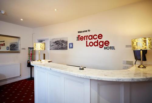 a bathroom with a large sign on the wall at The Terrace Lodge Hotel in Yeovil