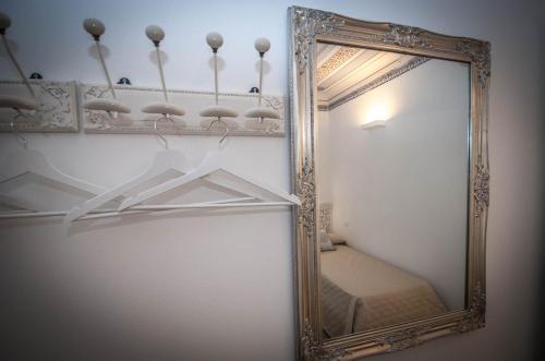 a mirror hanging on a wall in a room at Luxury Apartments Manarola by Arbaspàa in Manarola