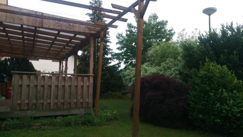 a wooden gazebo in a yard with a fence at Ferienhaus Bornscheuer in Gerstungen