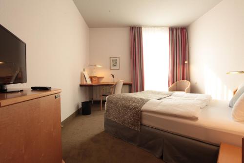 A bed or beds in a room at Hotel Haus Duden