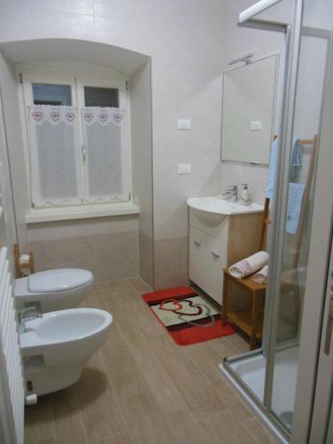 a bathroom with a toilet and a sink at B&B al Capitello in Trento
