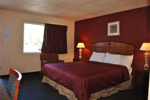 a hotel room with a bed and a window at Budget Inn in San Luis Obispo