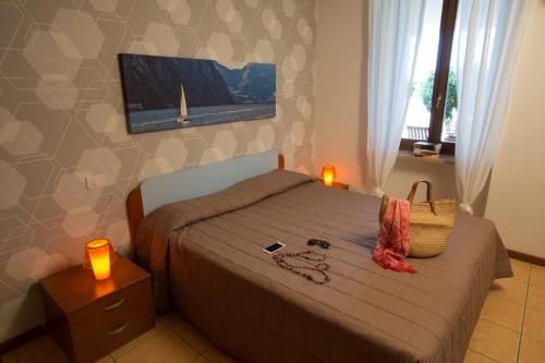 a bedroom with a bed with a purse on it at La Rocca Camping Village in Bardolino