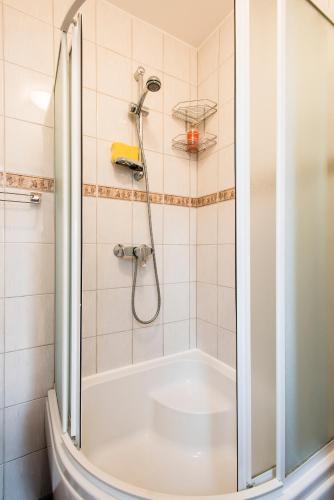 a shower with a glass door in a bathroom at Holiday Home Ermine in Sigulda